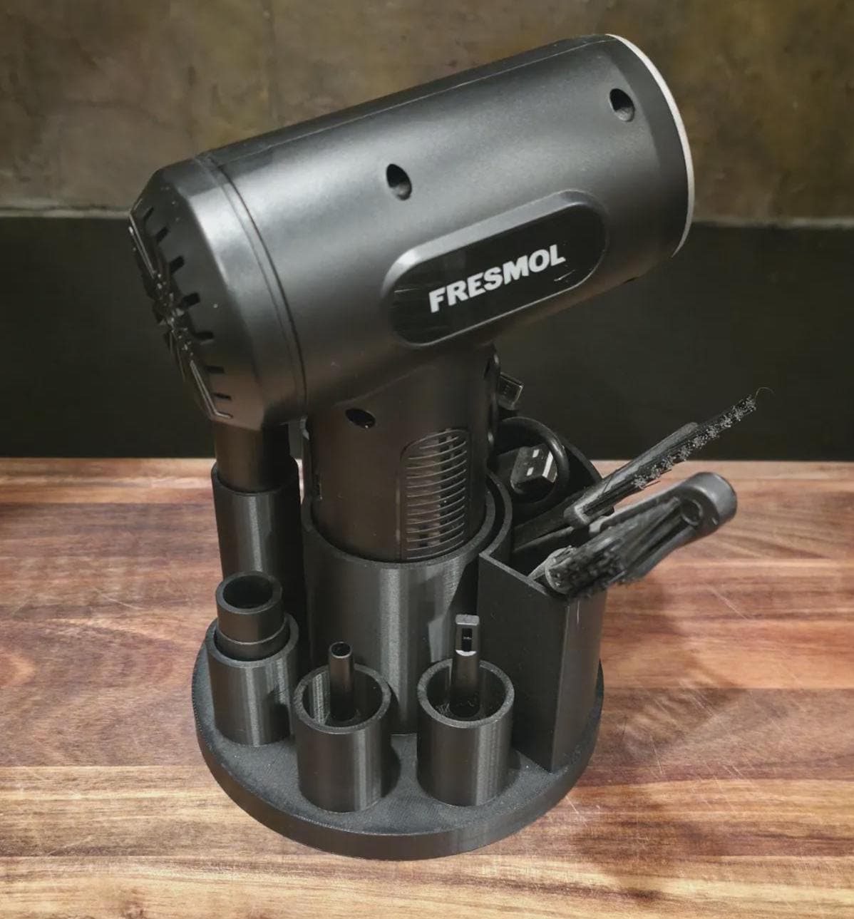 Handheld air duster and attachments stored in a black 3D-printed organizer